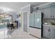 Dining area with gray cabinets, matching refrigerator, and modern decor at 54 Andora Ct, Kissimmee, FL 34758