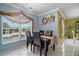 Dining area with stylish decor and a view of the pool through a large window at 54 Andora Ct, Kissimmee, FL 34758