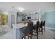 Modern kitchen with an island featuring seating, cabinets, and sleek appliances at 54 Andora Ct, Kissimmee, FL 34758