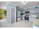 Charming kitchen features gray cabinets, stainless steel appliances, and modern tiled backsplash at 54 Andora Ct, Kissimmee, FL 34758