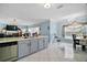 Bright kitchen featuring gray cabinets, an island with a sink, and an adjacent eating area at 54 Andora Ct, Kissimmee, FL 34758