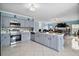 Contemporary kitchen with stainless steel appliances, island, and open layout to living area at 54 Andora Ct, Kissimmee, FL 34758