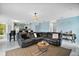 Cozy living room with sectional sofa, central table, and open to kitchen area at 54 Andora Ct, Kissimmee, FL 34758