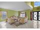 Sophisticated living room with large windows, ornate sofas, and ample natural light at 54 Andora Ct, Kissimmee, FL 34758