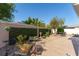 Cozy backyard patio surrounded by lush greenery, providing a private outdoor space at 648 Mission Hills Trl, The Villages, FL 32162