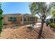 Cozy backyard with an area of gravel, concrete patio, and mature tree at 648 Mission Hills Trl, The Villages, FL 32162