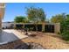 Private backyard area with gravel, patio, seating, and privacy wall and landscaping at 648 Mission Hills Trl, The Villages, FL 32162