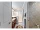 Tastefully designed bathroom with granite countertops, a glass door shower, and elegant decorative touches at 648 Mission Hills Trl, The Villages, FL 32162