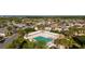 The community pool is surrounded by lush landscaping and lounge chairs at 648 Mission Hills Trl, The Villages, FL 32162