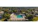 Community pool and lounge area surrounded by landscaping and walkways at 648 Mission Hills Trl, The Villages, FL 32162
