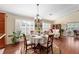 Charming dining area with window views, a chandelier, and seating for four, blending comfort and style at 648 Mission Hills Trl, The Villages, FL 32162