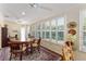Dining room featuring hardwood floors, plantation shutters, and an inviting atmosphere at 648 Mission Hills Trl, The Villages, FL 32162