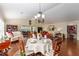 Sunlit dining area with hardwood floors, seamlessly connecting to living spaces for easy entertaining at 648 Mission Hills Trl, The Villages, FL 32162