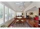 Bright dining area with plantation shutters, hardwood floors, and an open concept layout at 648 Mission Hills Trl, The Villages, FL 32162