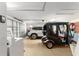 Bright garage with a car, golf cart, and washer at 648 Mission Hills Trl, The Villages, FL 32162