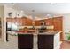 Bright kitchen features granite countertops, wood cabinetry, and stainless steel appliances at 648 Mission Hills Trl, The Villages, FL 32162
