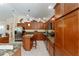 Spacious kitchen featuring granite countertops, wood cabinets, and stainless steel appliances at 648 Mission Hills Trl, The Villages, FL 32162
