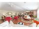 Open-concept living room and dining area with hardwood floors, elegant furnishings, and ample natural light at 648 Mission Hills Trl, The Villages, FL 32162