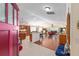 Open-concept home with a spacious kitchen flowing into the living area with hardwood floors, and lots of natural light at 648 Mission Hills Trl, The Villages, FL 32162