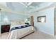 Comfortable main bedroom with a vaulted ceiling, soft carpeting, and a soothing color palette at 648 Mission Hills Trl, The Villages, FL 32162