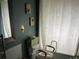 Accessible bathroom with decorative butterfly art, leaf pattern shower curtain and safety features at 6619 Ona Ct, Clermont, FL 34714