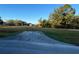 View of home exterior showing driveway and spacious front lawn at 6619 Ona Ct, Clermont, FL 34714