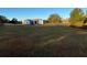 A spacious home exterior is surrounded by a lush green lawn and mature trees at 6619 Ona Ct, Clermont, FL 34714