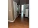 Hallway with wood floors leading to bathroom and other rooms at 6619 Ona Ct, Clermont, FL 34714