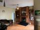 Cozy living room with fireplace, built-in shelving and ceiling fan at 6619 Ona Ct, Clermont, FL 34714