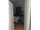 A storage room with wood floors, white cabinets and silver hardware offers space for organization at 6619 Ona Ct, Clermont, FL 34714