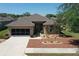 Aerial view of a well-maintained single-story home featuring a two-car garage at 6942 Sw 94Th Ct, Ocala, FL 34481