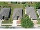 Overhead shot shows the home's roof and its location in a community with manicured lawns at 6942 Sw 94Th Ct, Ocala, FL 34481