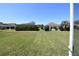 Well-maintained backyard featuring a manicured lawn and views of the surrounding neighborhood at 6942 Sw 94Th Ct, Ocala, FL 34481