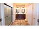 Bathroom featuring double sinks, granite countertops, ceramic tile floor, and a glass-enclosed shower at 6942 Sw 94Th Ct, Ocala, FL 34481