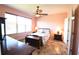 Serene bedroom with warm-toned walls, a ceiling fan and ample natural light at 6942 Sw 94Th Ct, Ocala, FL 34481