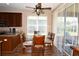 Eat-in kitchen dining room with a glass dining table, ceiling fan, and sliding glass door to the outdoor patio at 6942 Sw 94Th Ct, Ocala, FL 34481