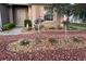 Landscaped front yard featuring rock and mulch ground cover, flowering bushes, and a concrete walkway to the front door at 6942 Sw 94Th Ct, Ocala, FL 34481