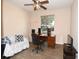 Home office with a wooden desk, comfortable sofa, and a ceiling fan at 6942 Sw 94Th Ct, Ocala, FL 34481
