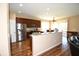 Well-lit kitchen featuring stainless steel appliances, wood cabinets, and breakfast bar at 6942 Sw 94Th Ct, Ocala, FL 34481