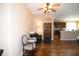 Inviting living room with hardwood floors, neutral paint, and open view into the adjacent kitchen at 6942 Sw 94Th Ct, Ocala, FL 34481