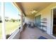 Covered patio includes a ceiling fan, dining area, and relaxing space with views of the green yard at 6942 Sw 94Th Ct, Ocala, FL 34481