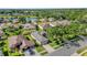 Aerial view of the property nestled in a serene community with a lake at 7034 Pine Hollow Dr, Mount Dora, FL 32757