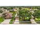 Aerial view of a home with a beautifully maintained front yard, landscaping, and driveway at 7034 Pine Hollow Dr, Mount Dora, FL 32757