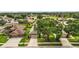 Overhead view of a landscaped home with a driveway nestled in a neighborhood at 7034 Pine Hollow Dr, Mount Dora, FL 32757