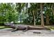 Large alligator statue surrounded by trees and greenery, offering a unique outdoor experience at 7034 Pine Hollow Dr, Mount Dora, FL 32757
