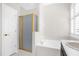 Bathroom featuring a shower with gold trim, a soaking tub, and white countertops at 7034 Pine Hollow Dr, Mount Dora, FL 32757