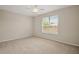 Cozy bedroom with neutral carpet, a ceiling fan and a large window for natural light at 7034 Pine Hollow Dr, Mount Dora, FL 32757