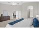 Spacious bedroom with neutral colors and views into the en suite bathroom and dining area at 7034 Pine Hollow Dr, Mount Dora, FL 32757