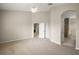 Spacious bedroom featuring neutral carpet, ceiling fan, and ensuite bathroom access at 7034 Pine Hollow Dr, Mount Dora, FL 32757