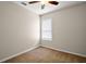 This cozy bedroom features neutral walls, carpet, and a ceiling fan for added comfort at 7034 Pine Hollow Dr, Mount Dora, FL 32757
